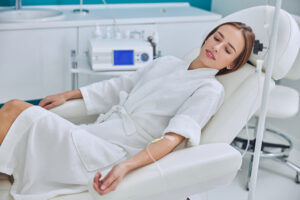 Beautiful young woman relaxing in a spa setting while getting IV Therapy for fresh, hydrated skin